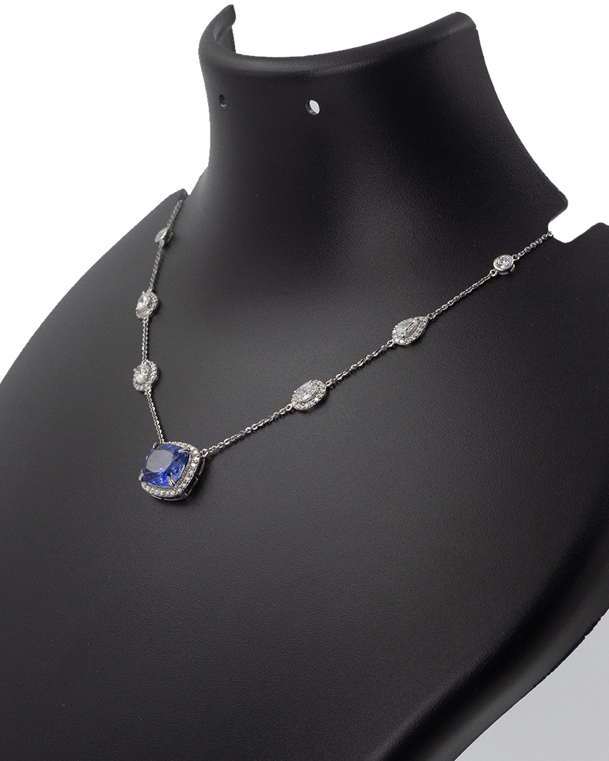 Cushion-cut blue sapphire with diamond halo in 14k yellow gold necklace
