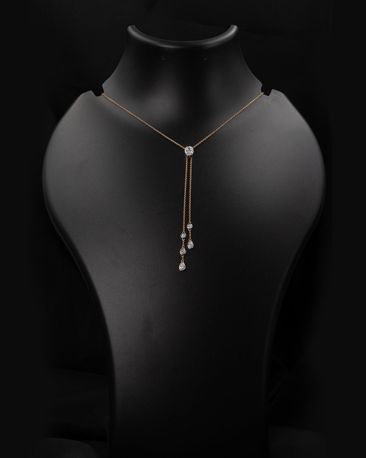 Necklace with diamond pendants on a black mannequin