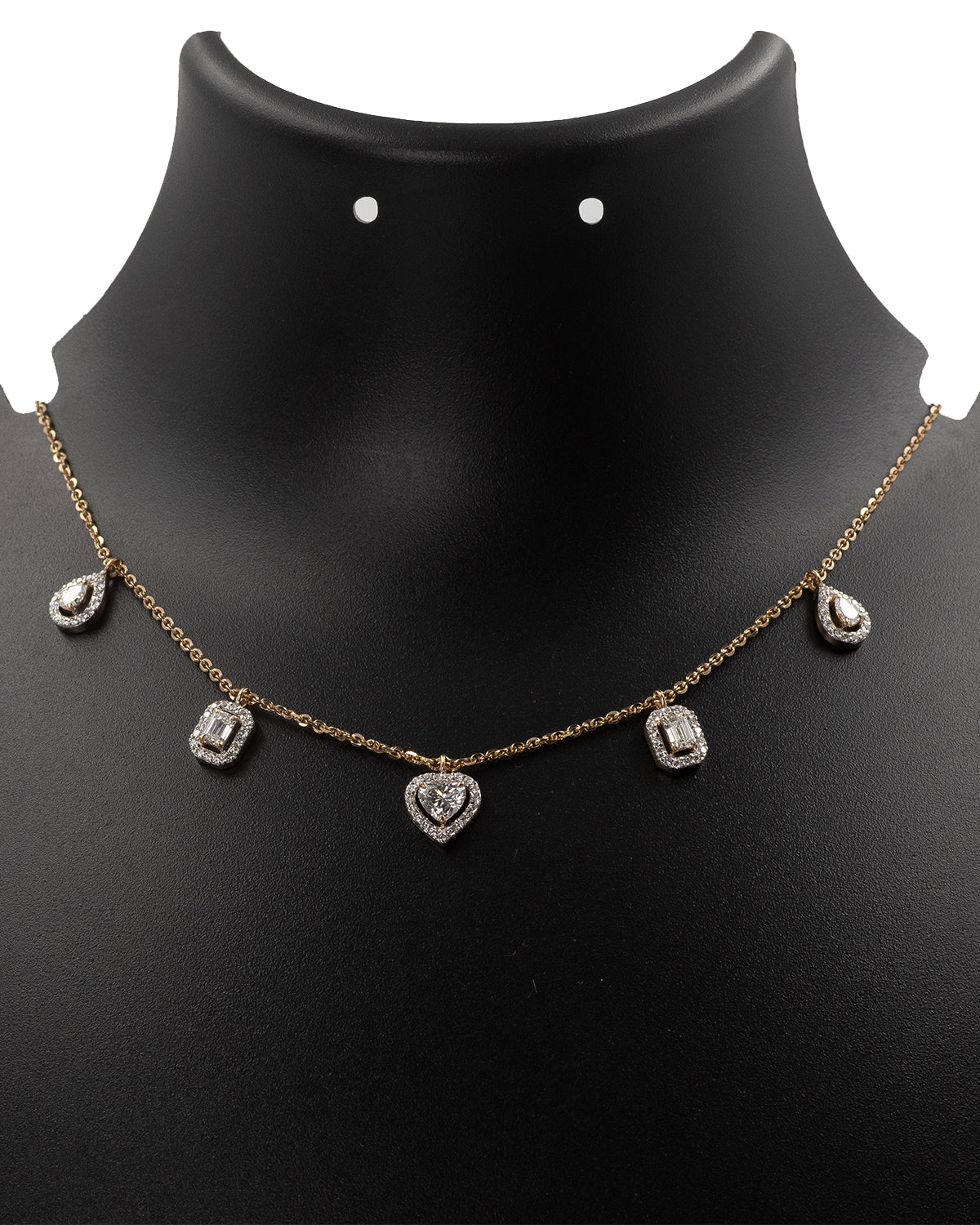 Necklace with heart and teardrop pendants on a black mannequin bust.