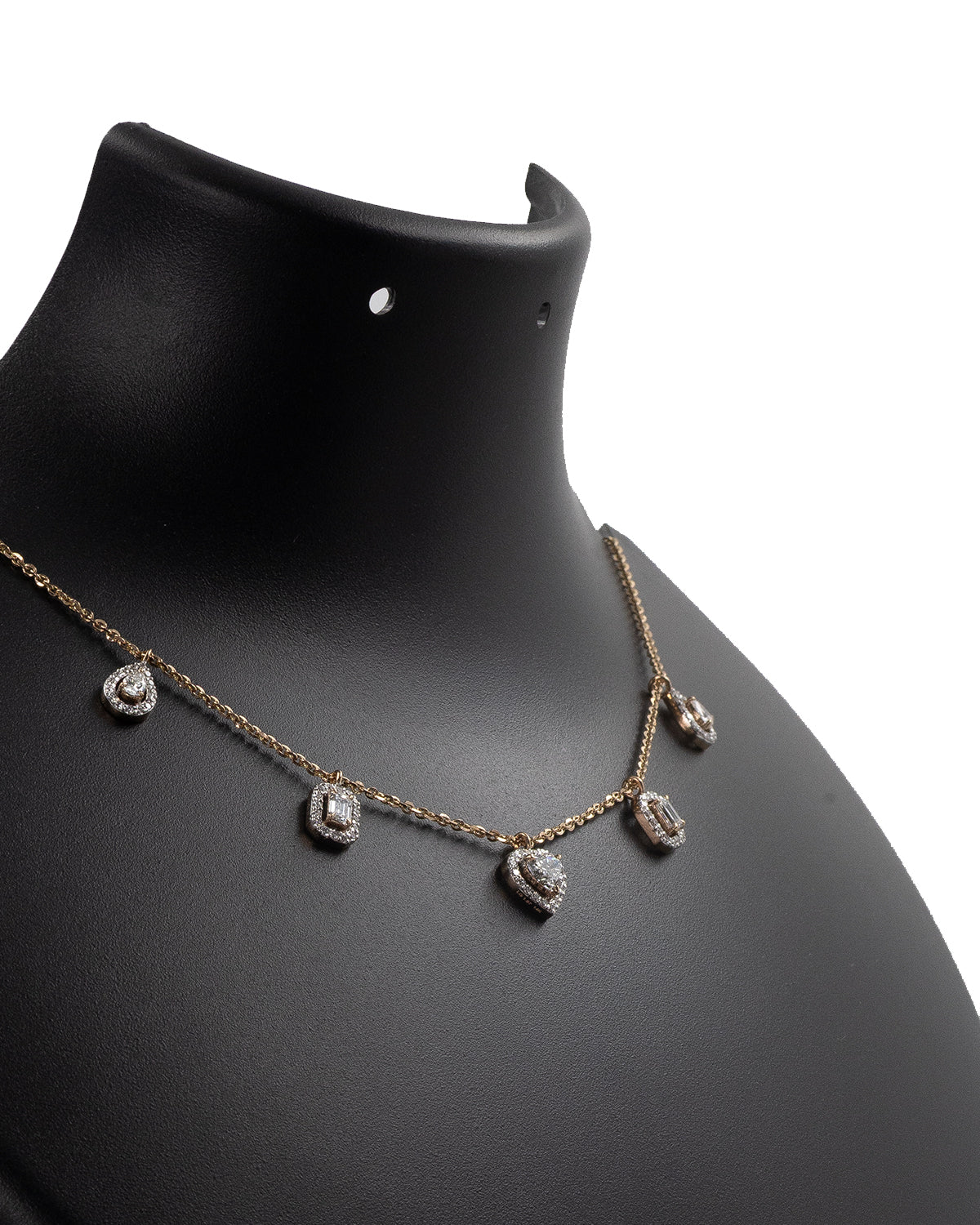 Necklace with diamond pendants on a black mannequin bust