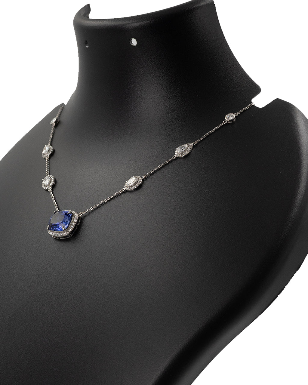 Side profile of blue sapphire and diamond necklace showing setting detail