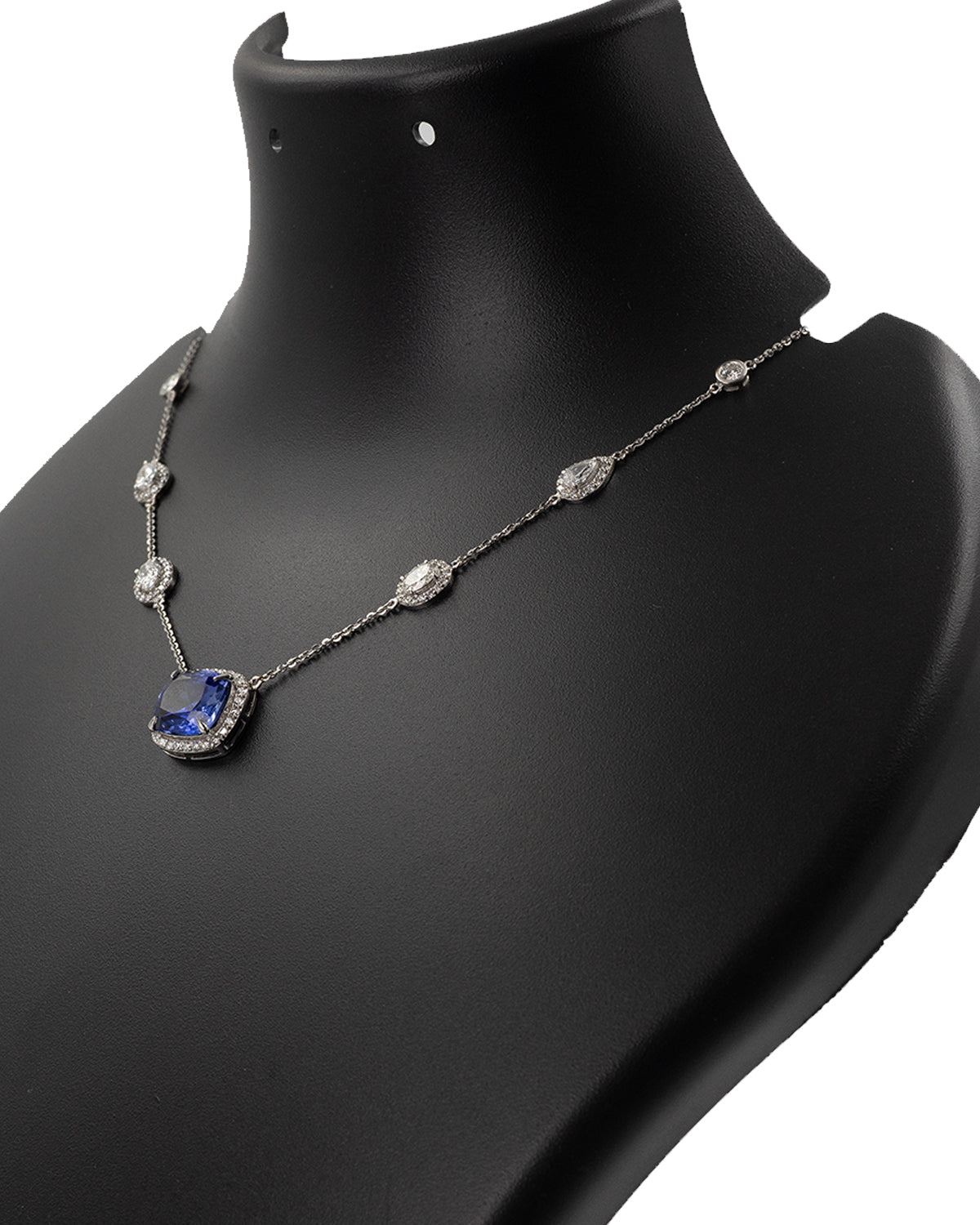 Side profile of blue sapphire and diamond necklace showing setting detail