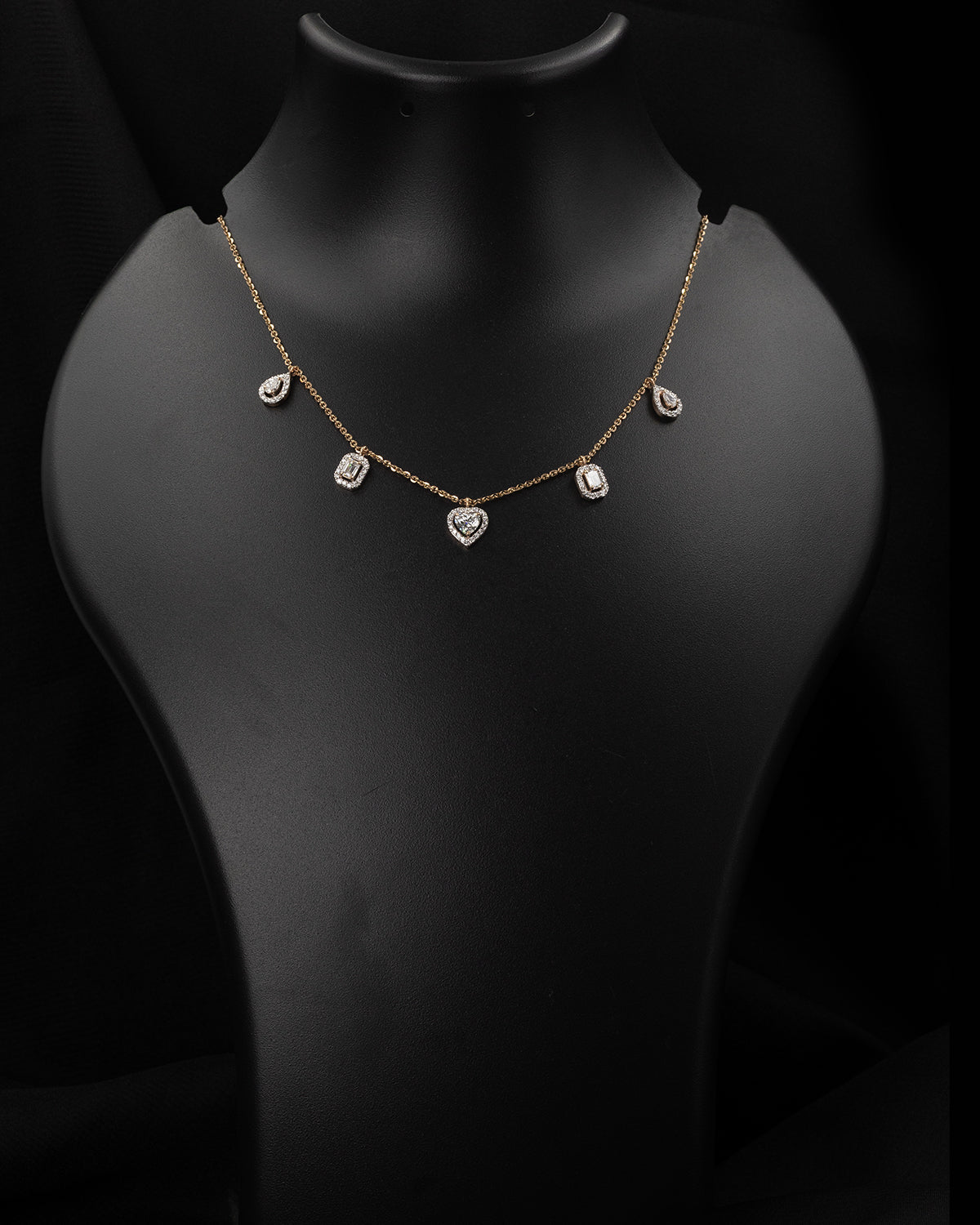 Necklace with heart-shaped pendants on a black mannequin