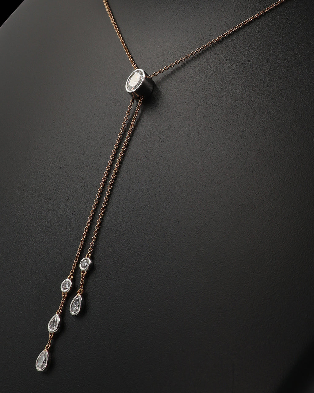 Necklace with teardrop-shaped pendants on a dark background