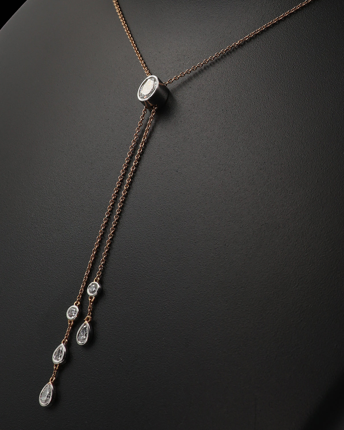 Necklace with teardrop-shaped pendants on a dark background
