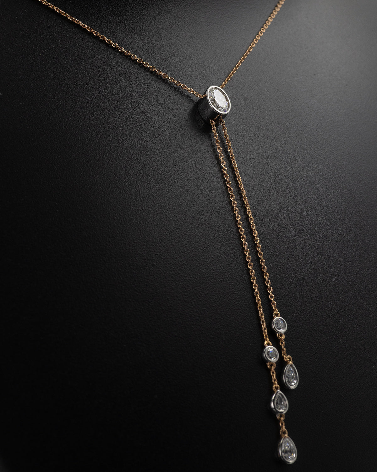 Necklace with diamond pendants on a dark background