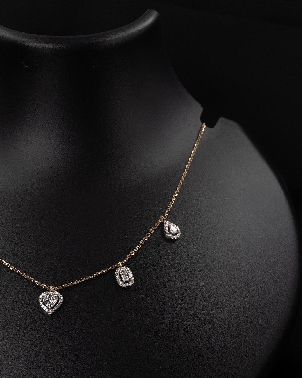 Necklace with heart and rectangular pendants on a black background