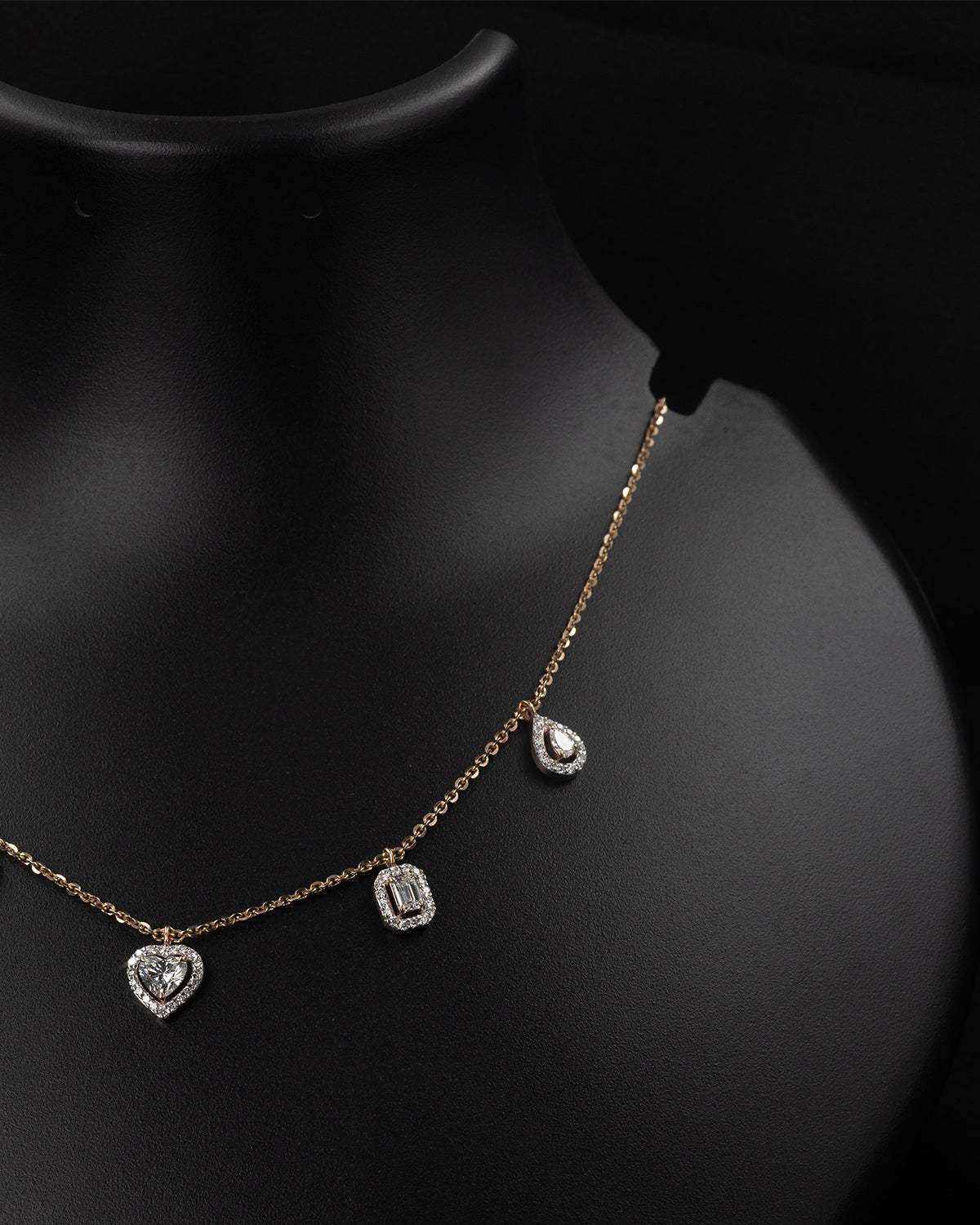 Necklace with heart and rectangular pendants on a black background