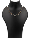 Gold necklace with heart-shaped pendants on a black mannequin bust.